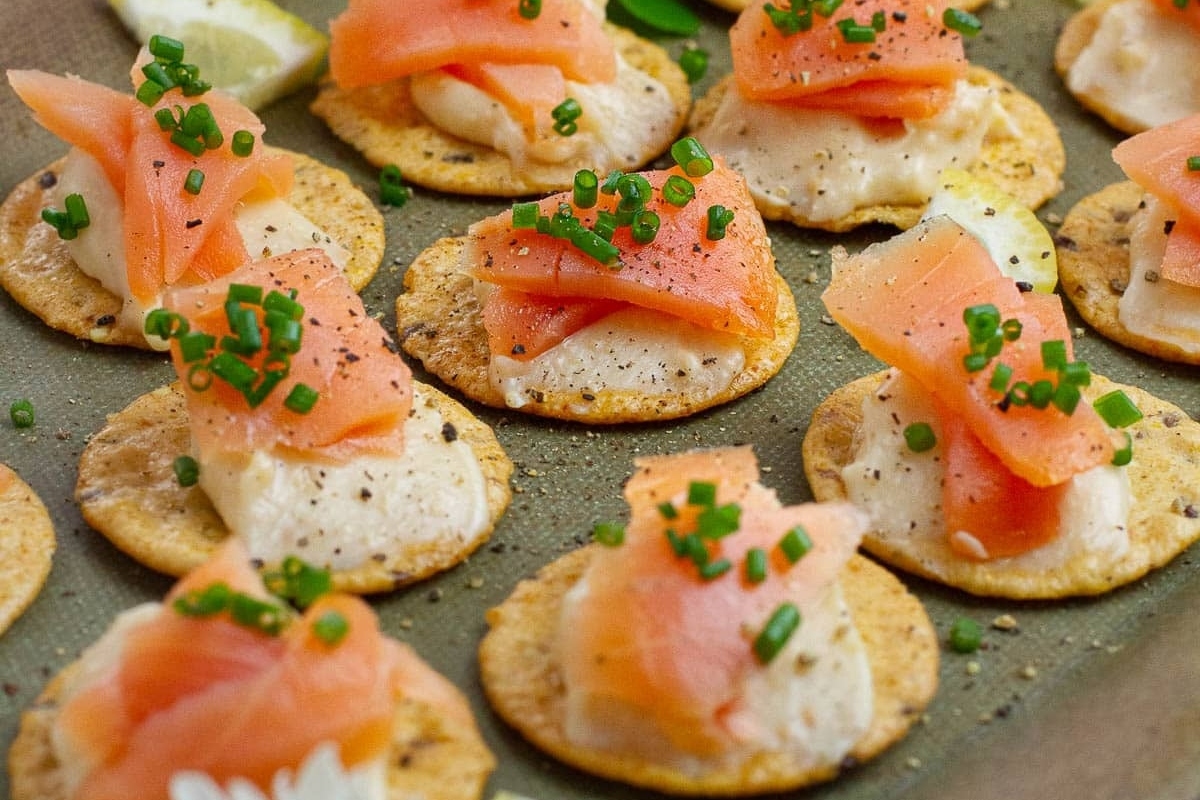 Smoked salmon appetizers with crackers for a delightful New Year's Eve treat.