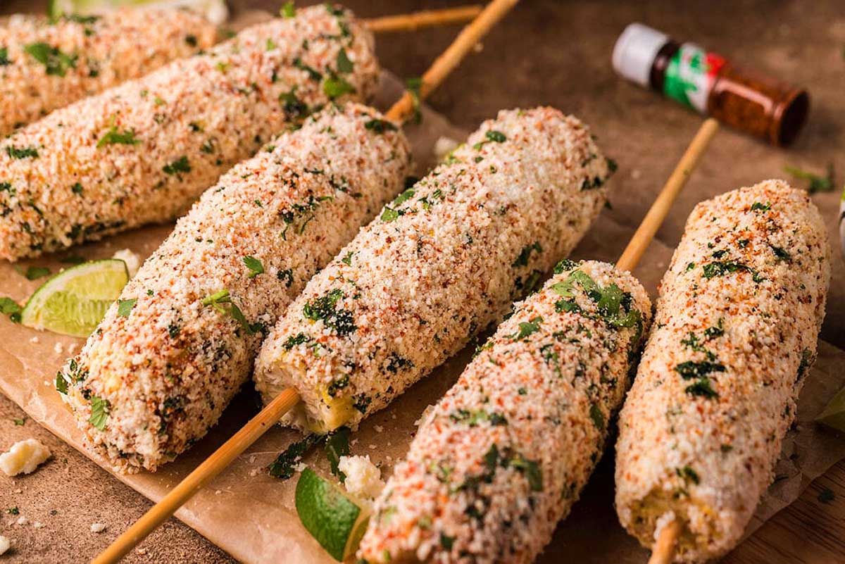 Corn on the cob with spices and herbs on a wooden board. This is one of the best Mexican recipes.
