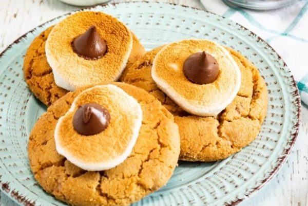 S'mores cookies on a plate with marshmallows on top.