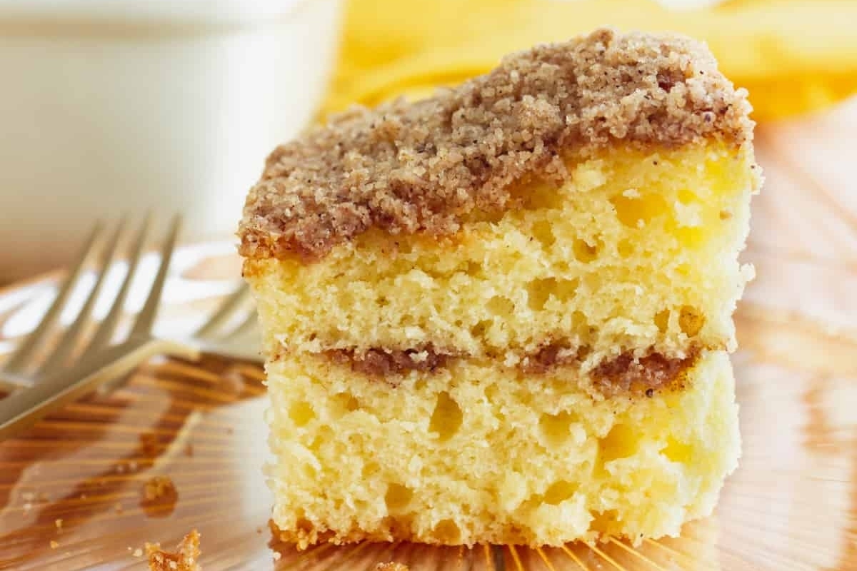 A slice of coffee cake on a plate with a fork, perfect for holiday mornings or enjoying at Starbucks.