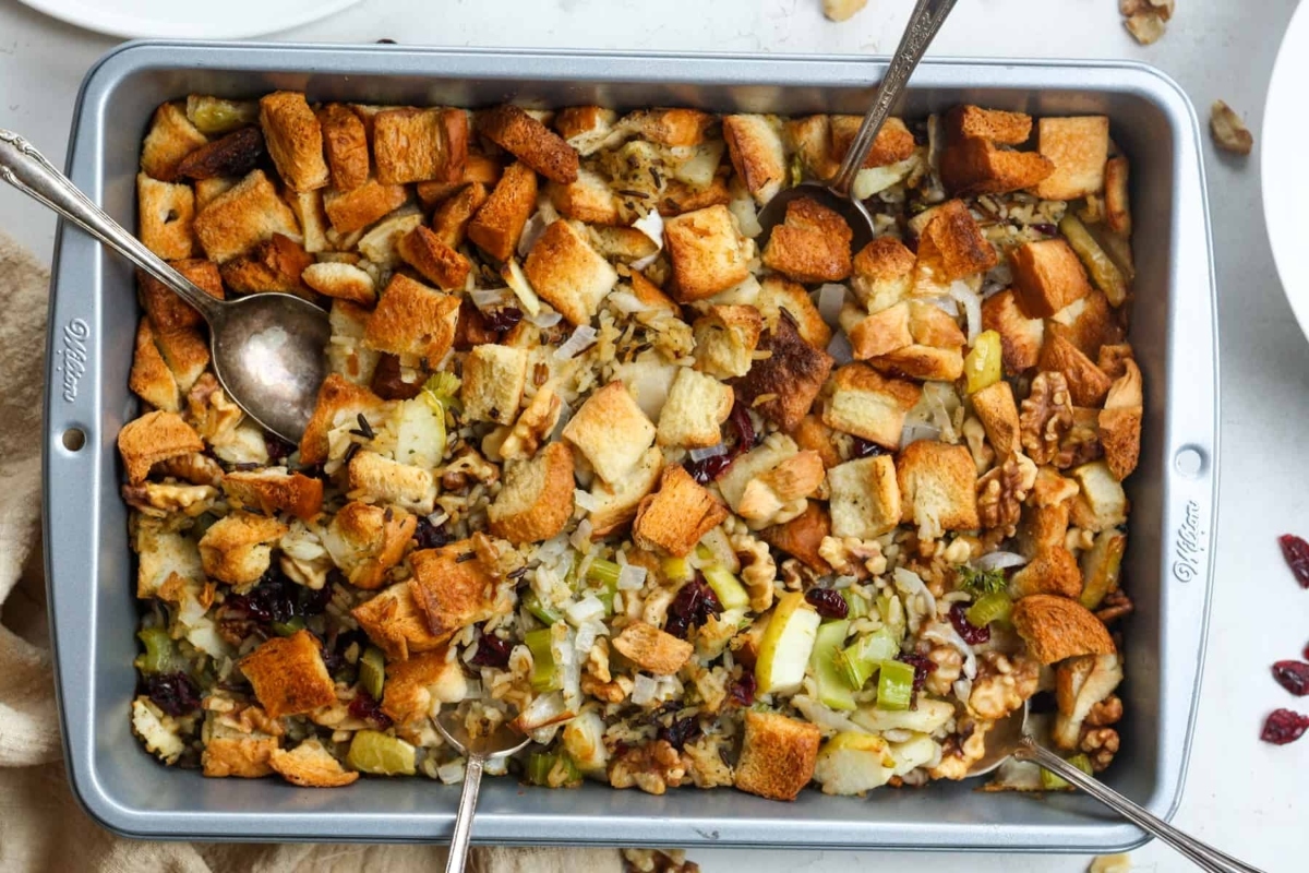 Sheet Pan Recipes: Cranberry stuffing in a pan with spoons, perfect for Thanksgiving.