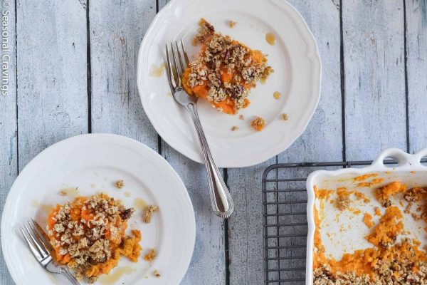 Sweet potato casserole on a plate with a fork.