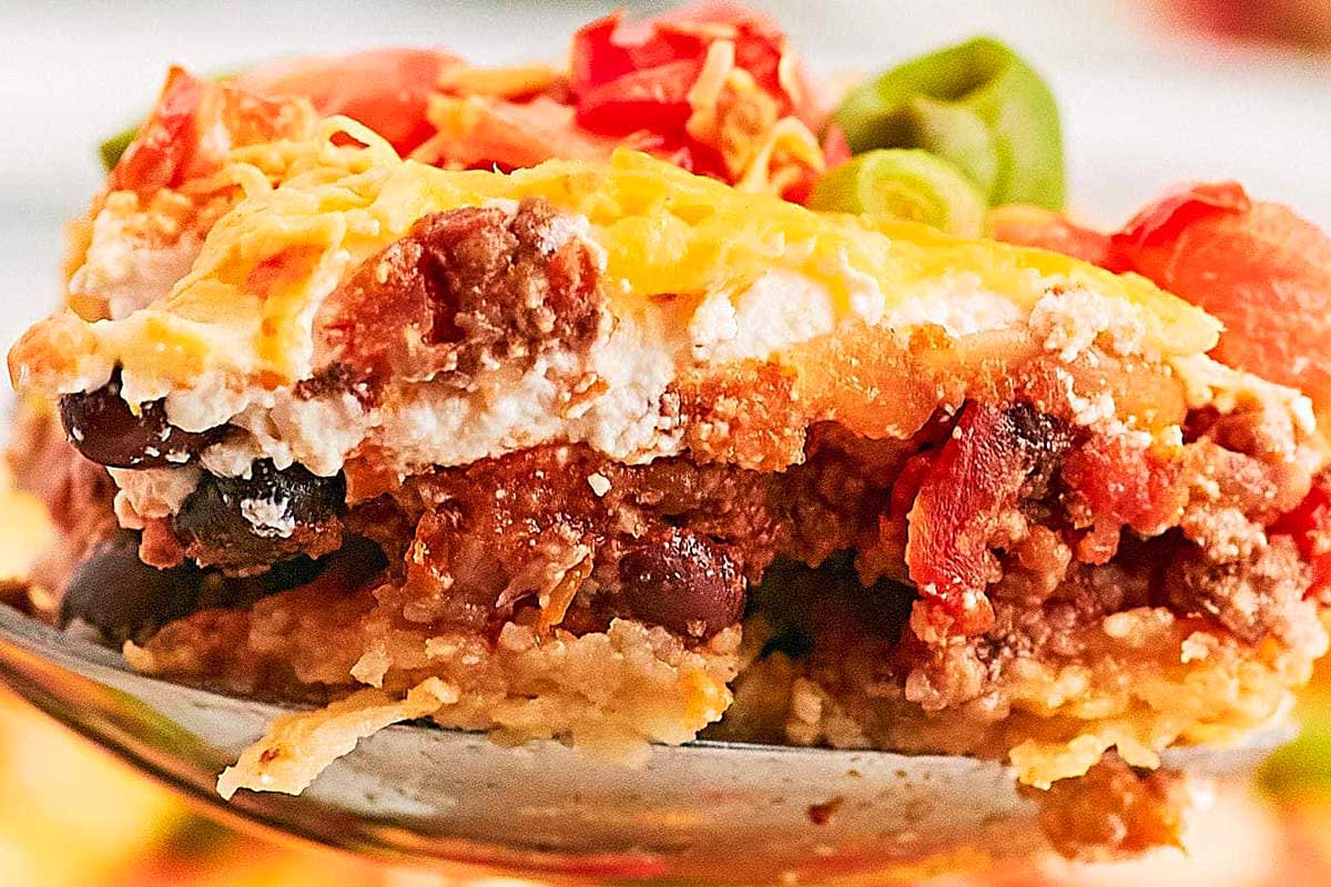 A piece of cheesy casserole on a spoon.