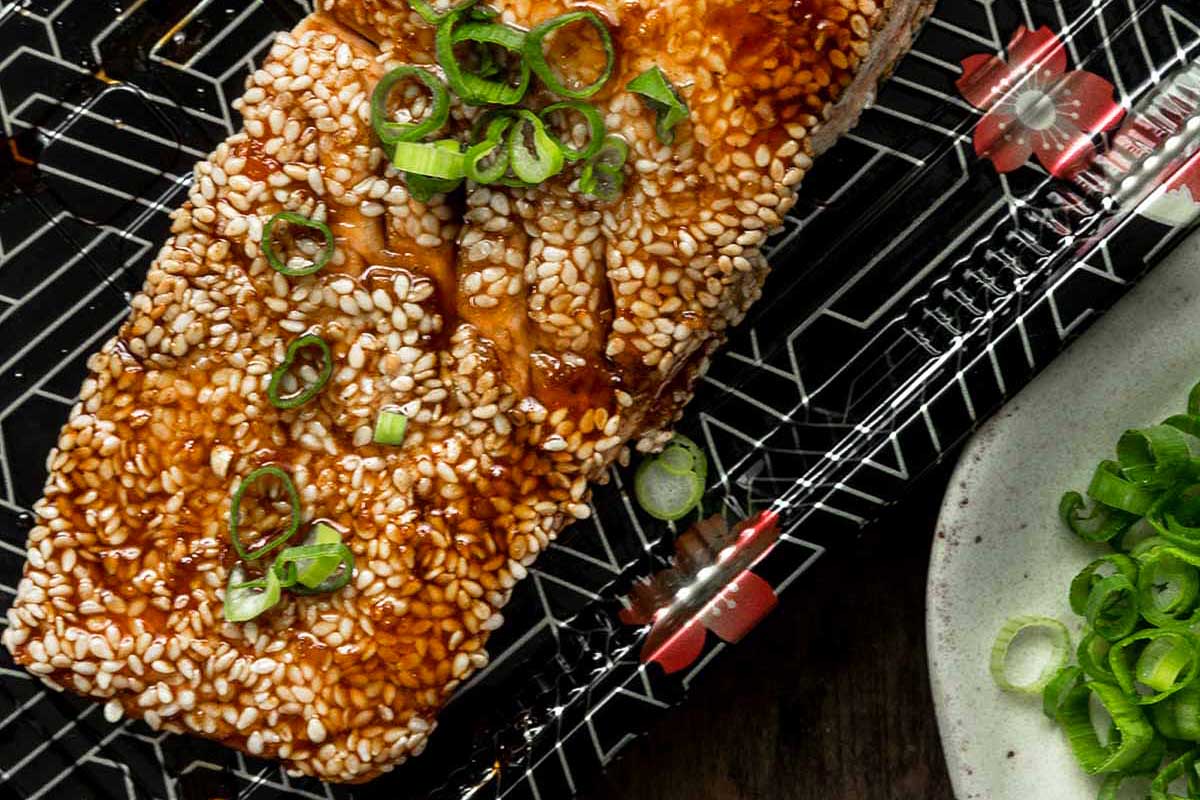 Salmon with sesame seeds and green onions.