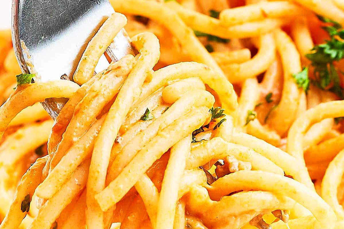 A fork is being used to eat spaghetti.