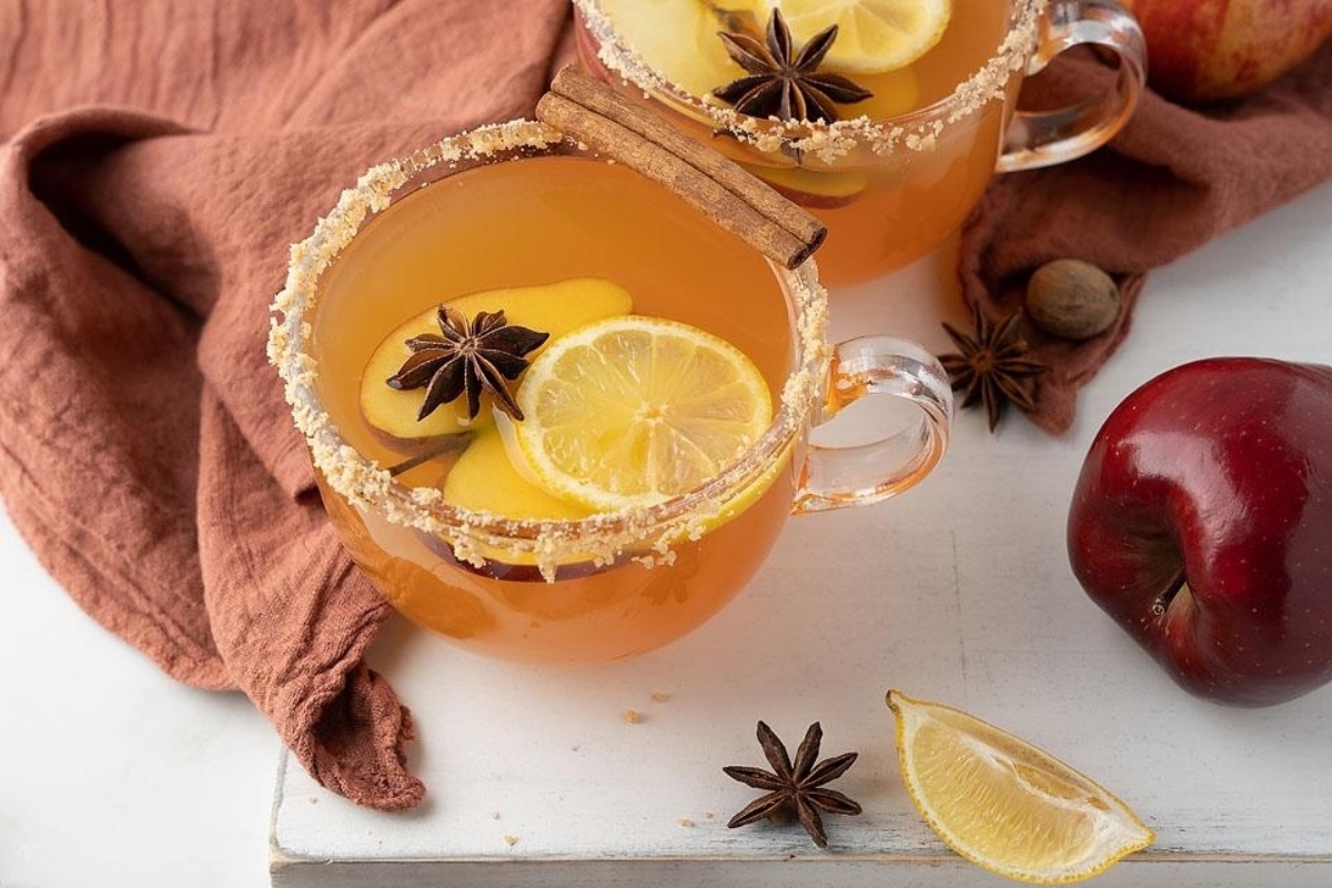 Two glasses of apple cider fireball cocktails.