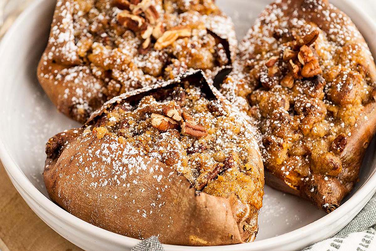 This sweet potato casserole is a delicious dish made with pecans and topped with powdered sugar.