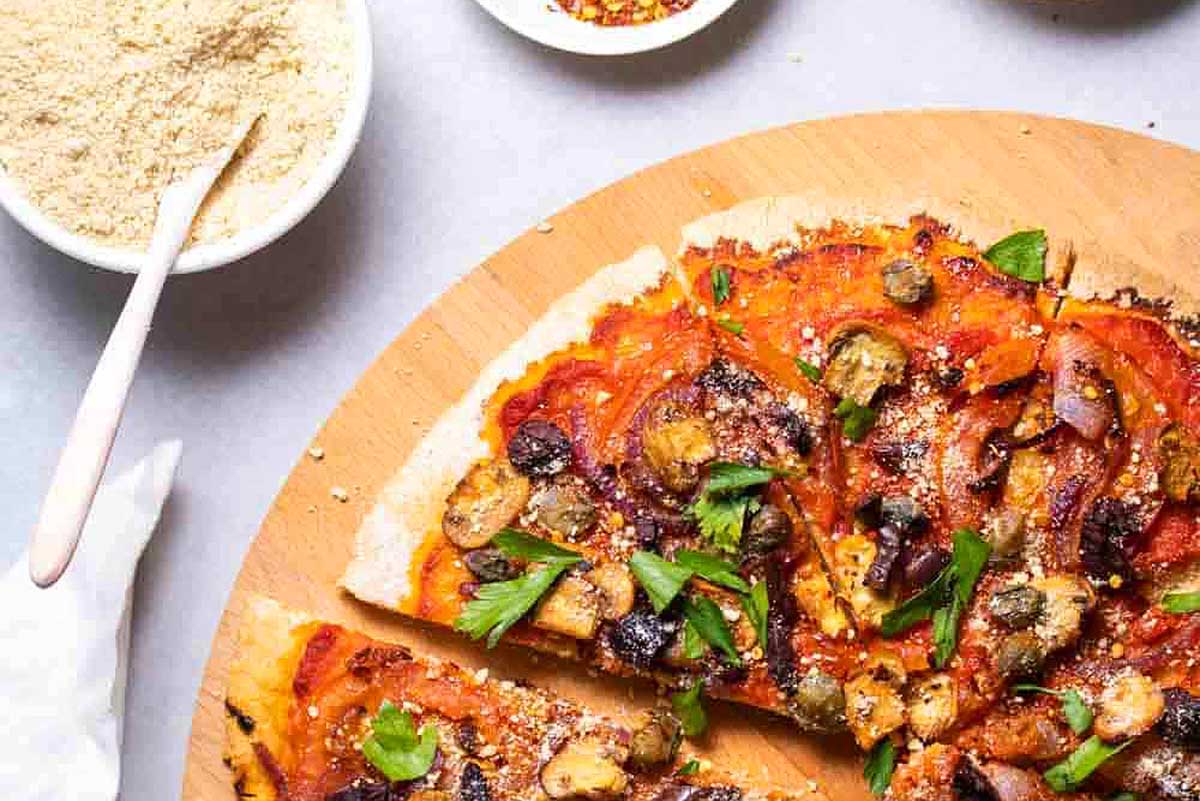 A slice of pizza on a wooden cutting board.