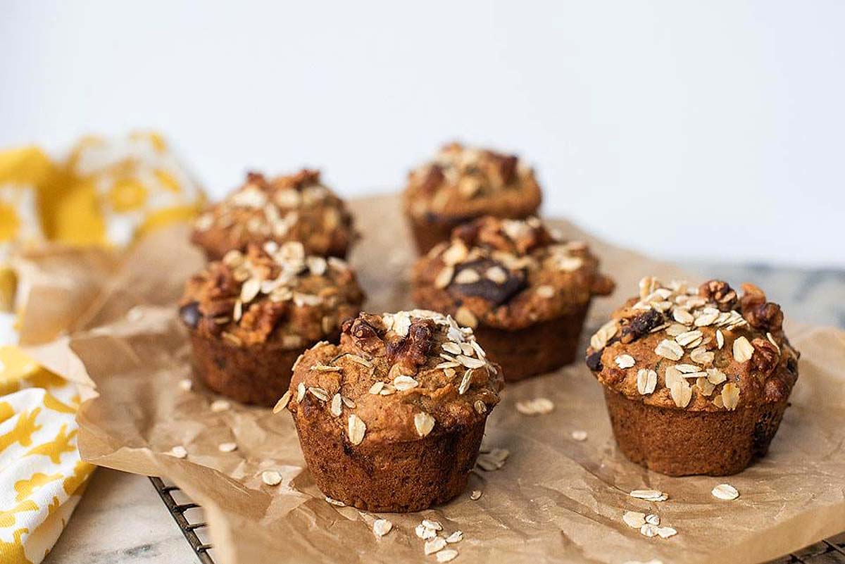 Zucchini banana oat muffins on a baking sheet.