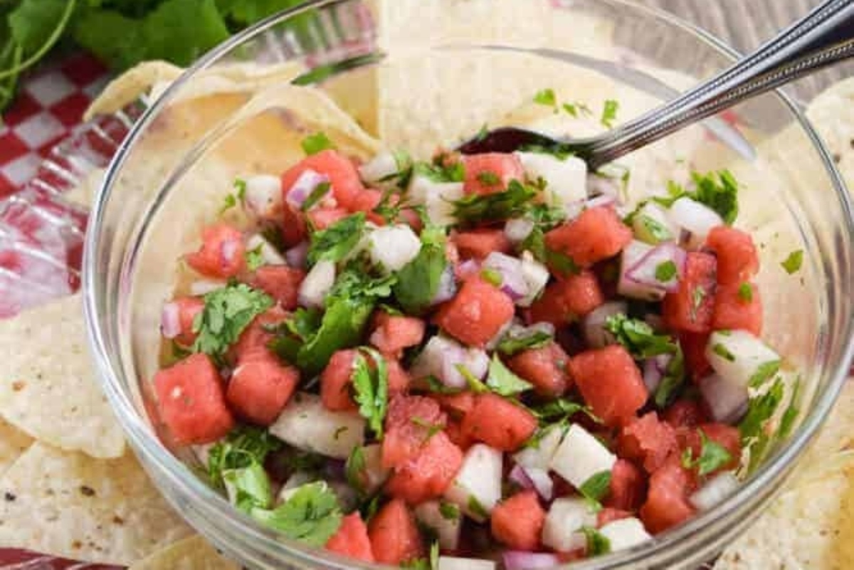 Watermelon salsa in a bowl with tortilla chips.