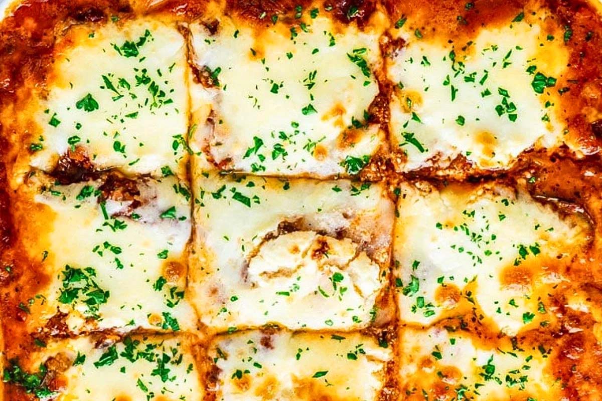 Lasagna made with zucchini in a square baking dish.