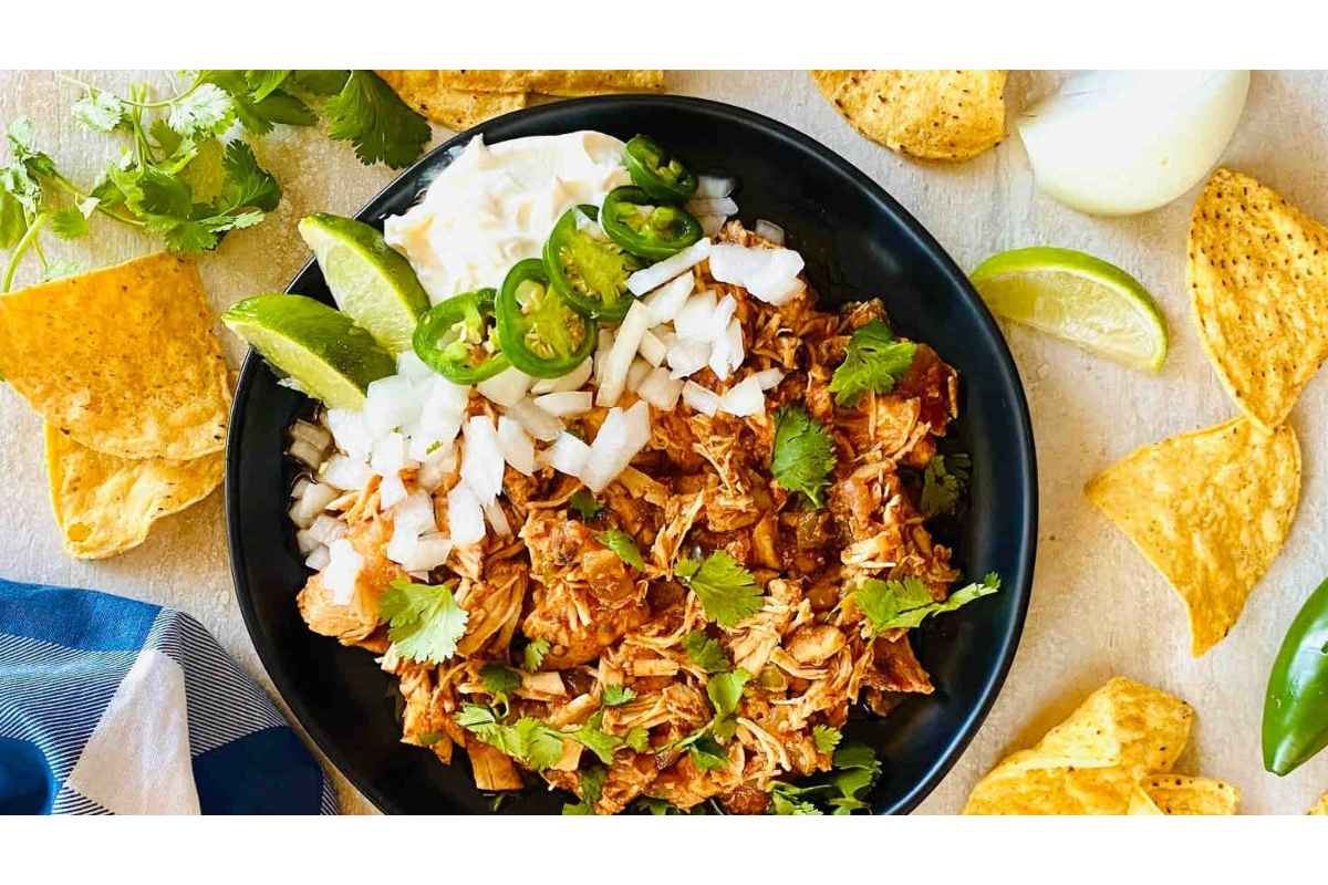 Healthy Mexican pulled pork on a plate with tortilla chips providing high protein.