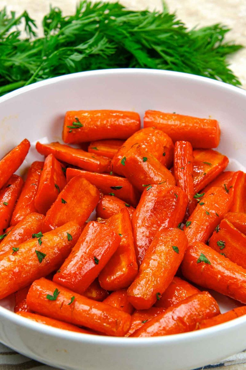 A white bowl with air fryer carrots in it.