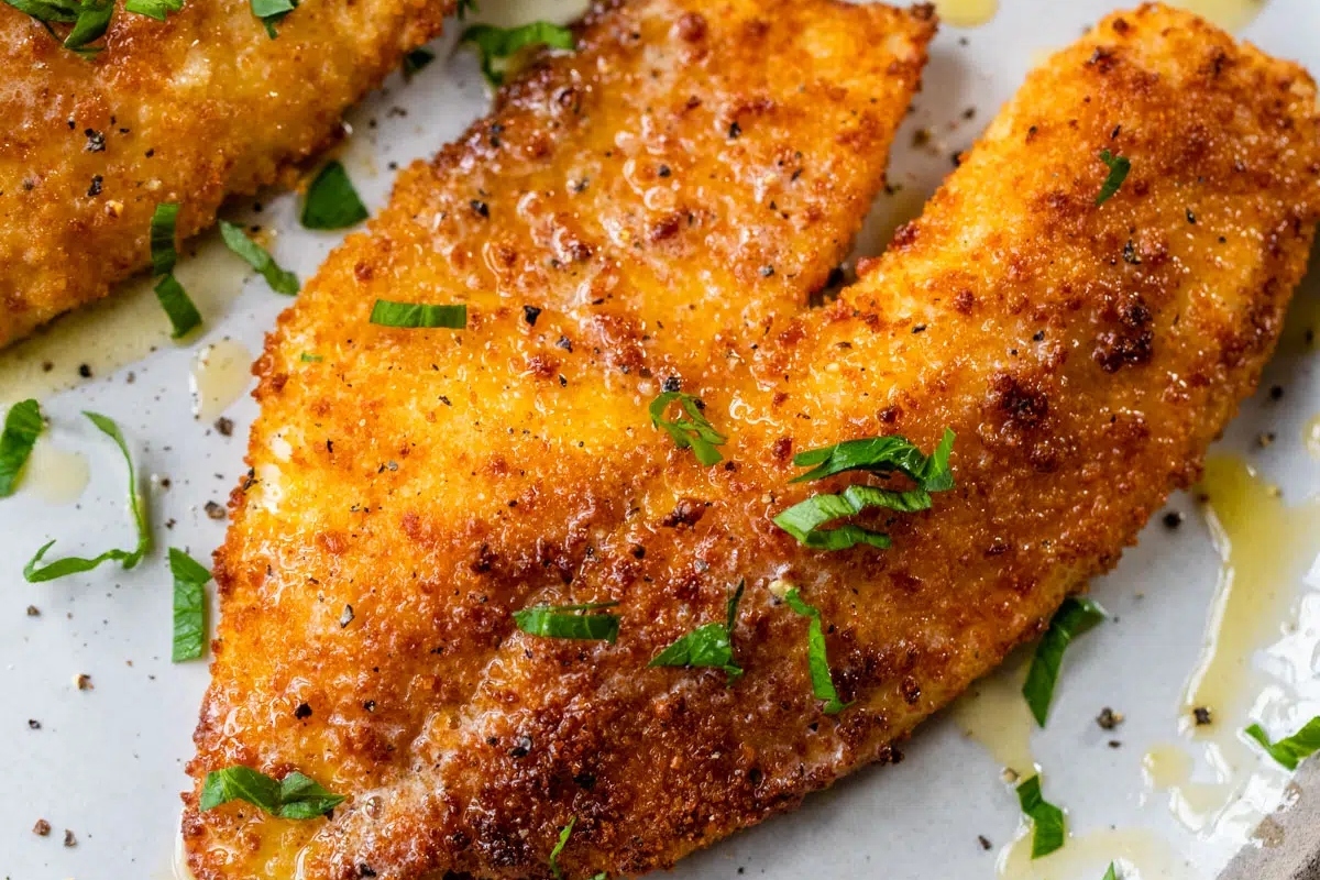 Two delicious fried fish fillets on a plate.