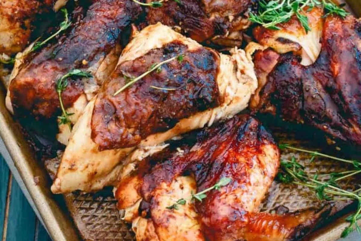 A winter dinner featuring roasted chicken on a baking sheet garnished with sprigs of thyme.