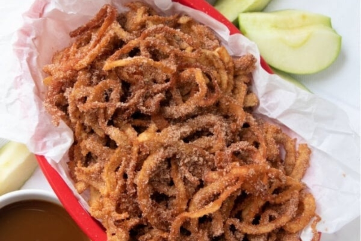 Spiralized fried apple rings in a red paper bag.