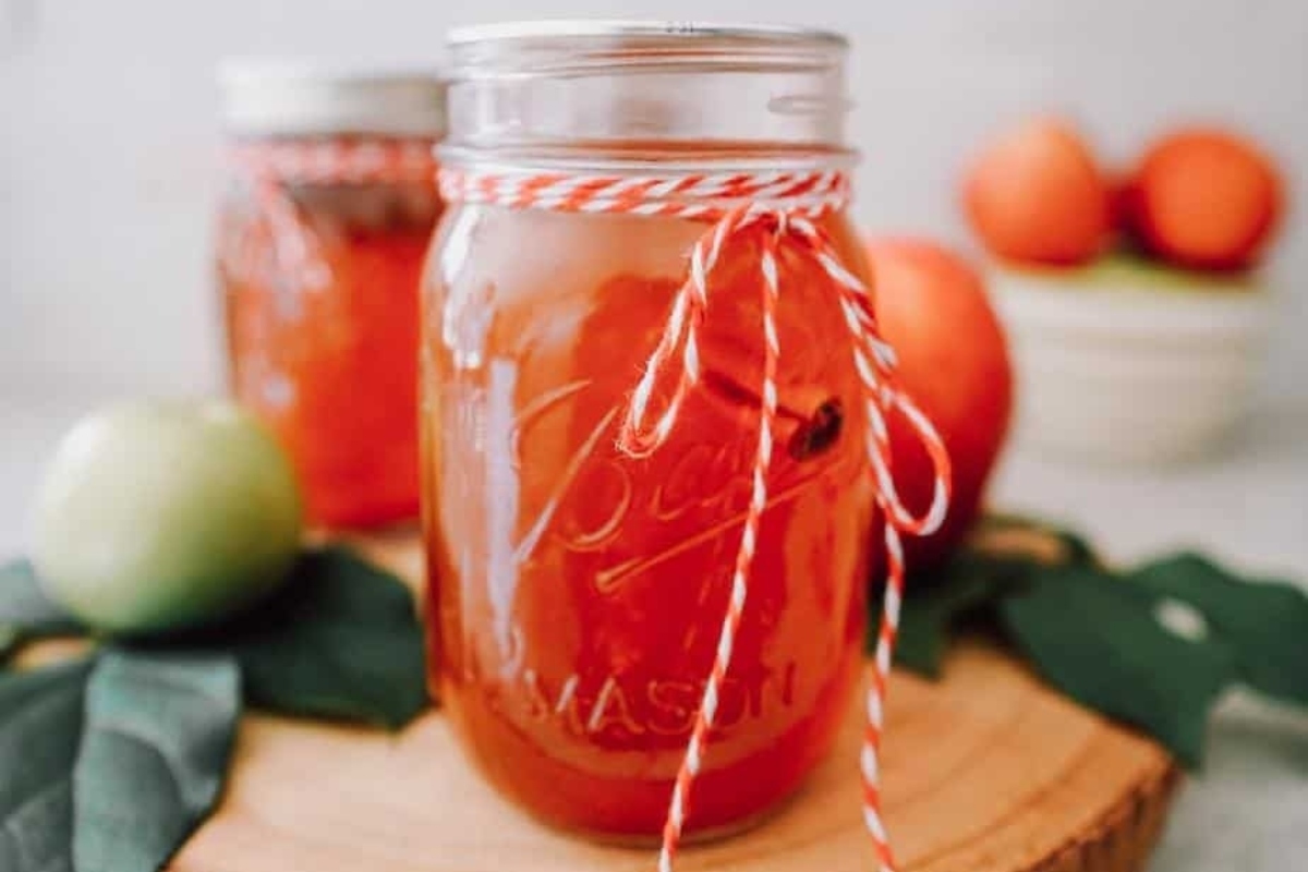 Two jar filled with apple cider, perfect gifts for any occasion.