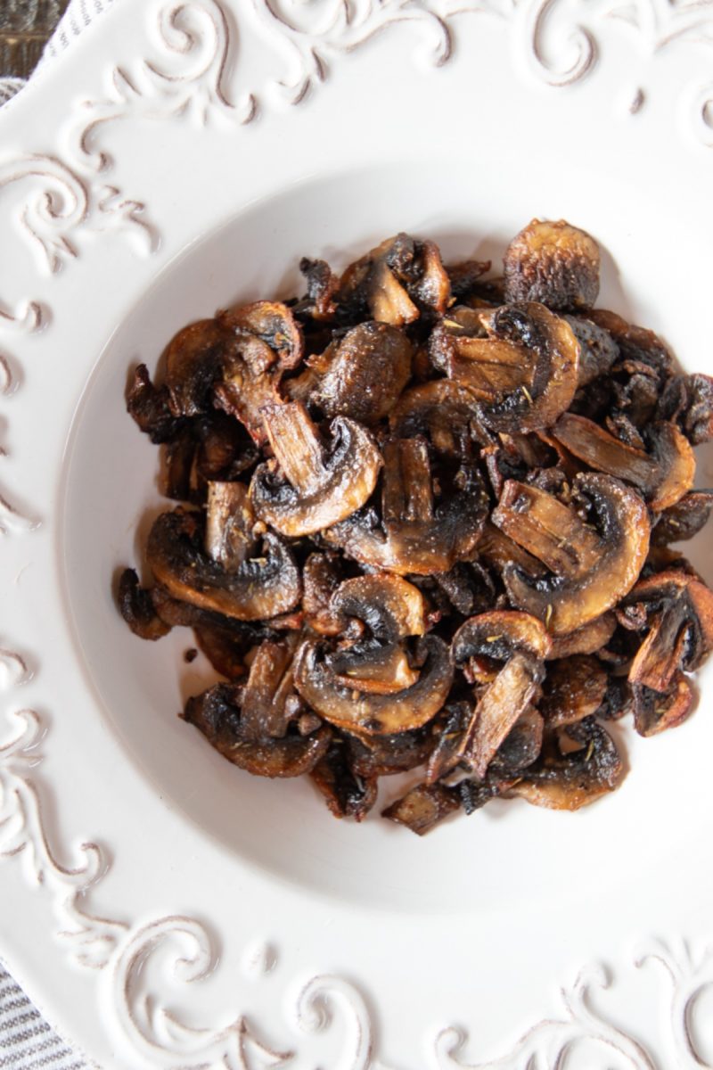 Air-fried mushrooms in a white plate on a table.