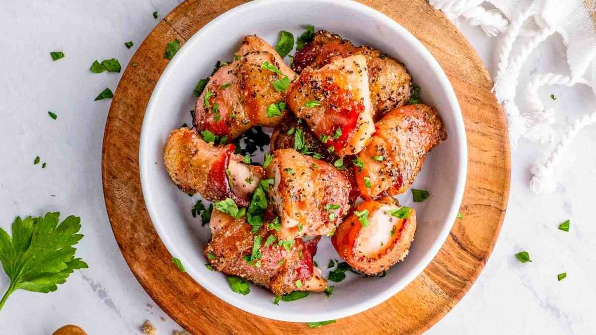 Bacon wrapped chicken in a bowl.