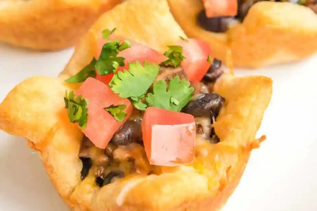 Mexican cheesecake bites on a white plate, perfect for game day snacking.