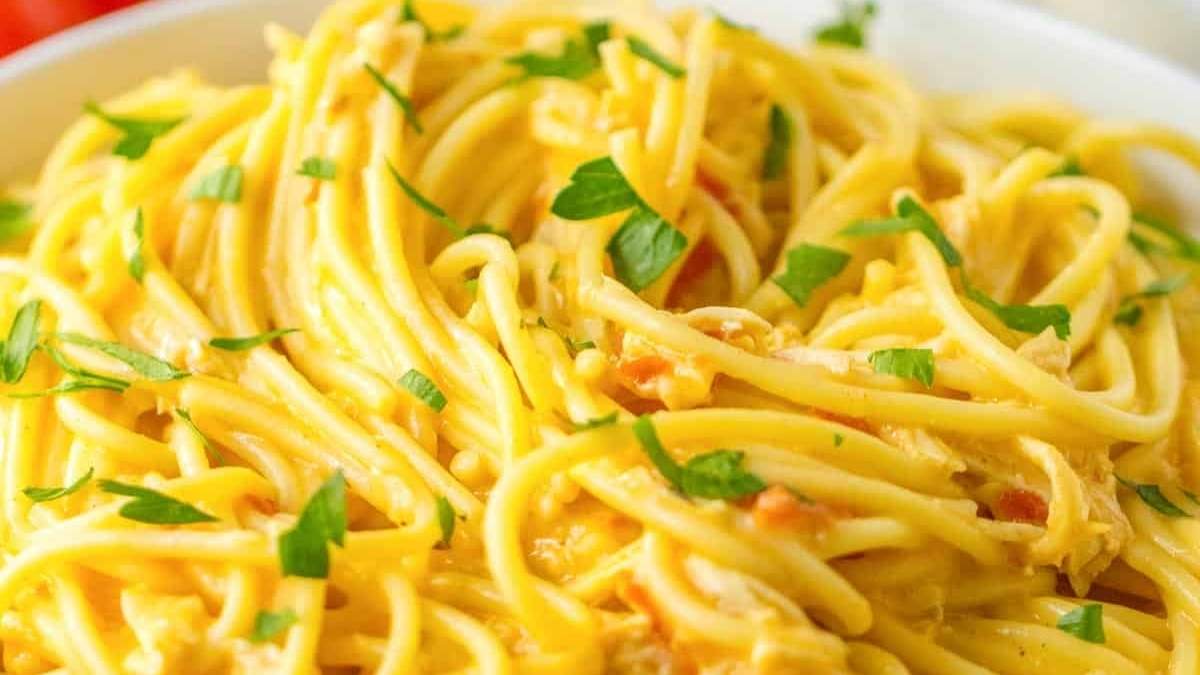 Comfort Food Recipes - A comforting bowl of pasta with flavorful chicken and fresh parsley.