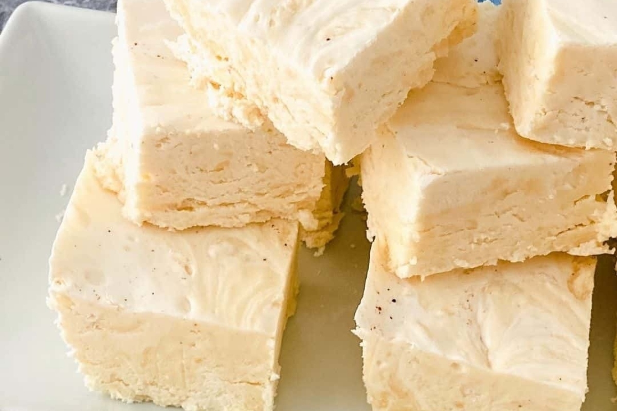 White fudge squares arranged on a plate.