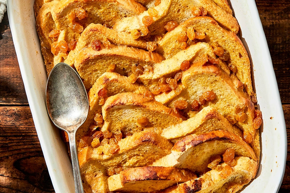 A sweet dish of bread pudding with a spoon in it, perfect for Christmas breakfast.
