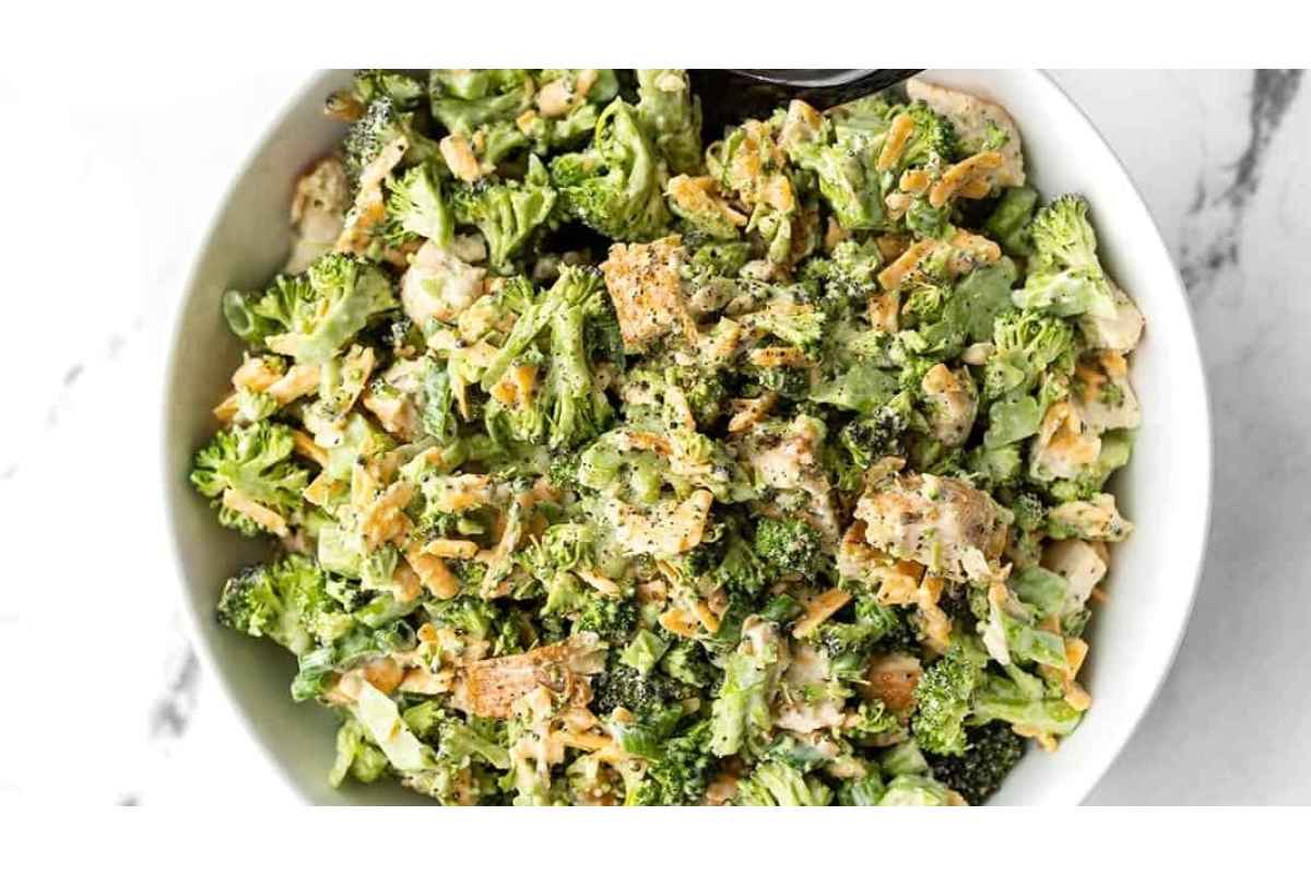 Healthy broccoli salad in a white bowl with croutons.