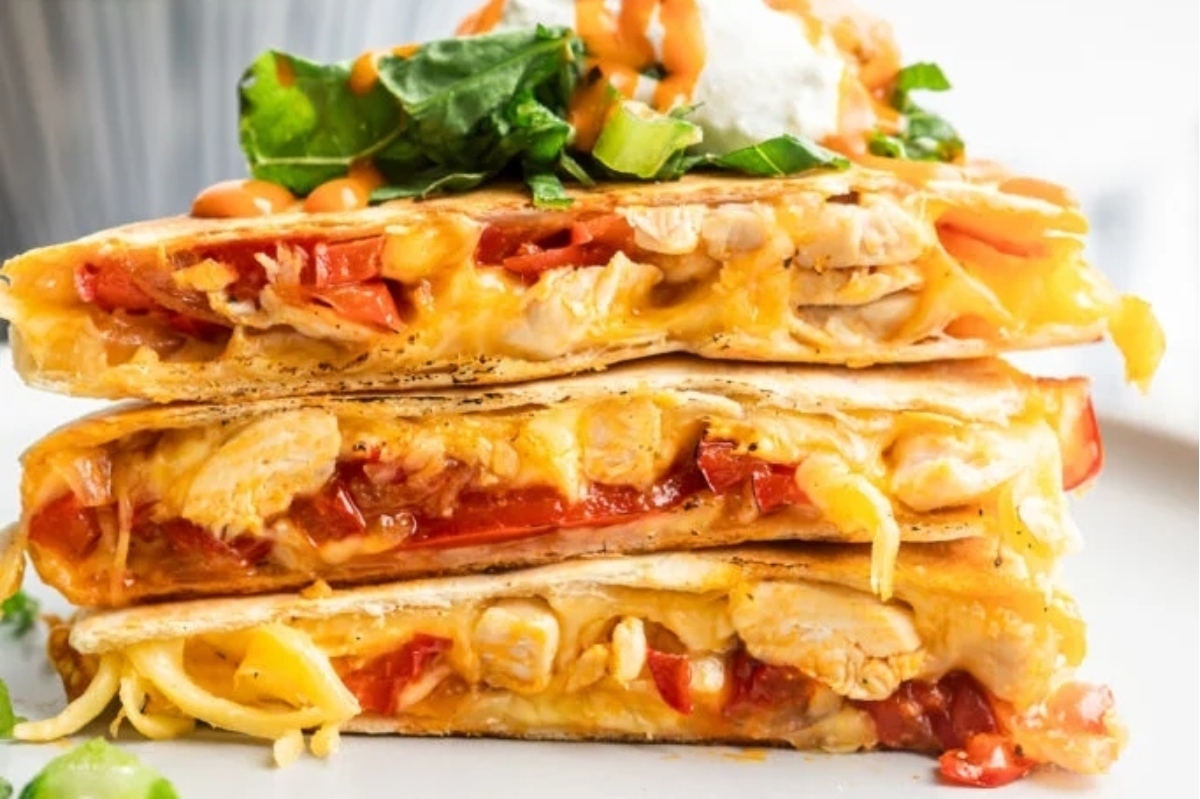 The easiest game day recipe, a stack of chicken quesadillas on a plate.