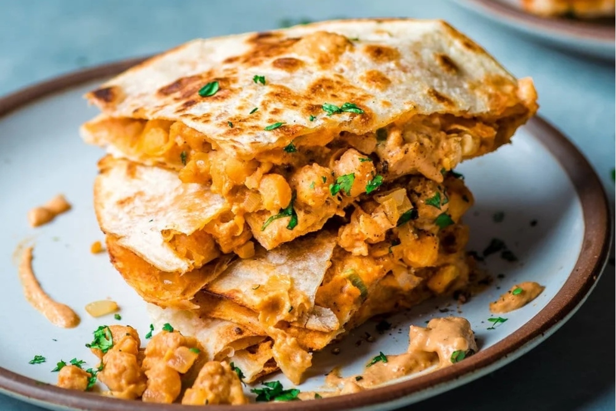 A stack of chicken quesadillas - perfect for Game Day or as a satisfying Main Dish - beautifully presented on a plate.