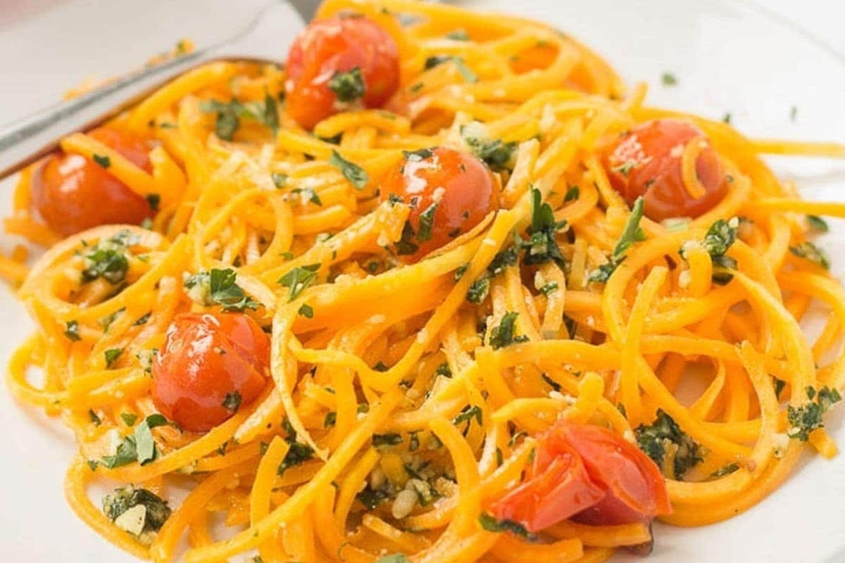 A flavorful plate of Spiralizer pasta with fresh tomatoes and aromatic herbs.