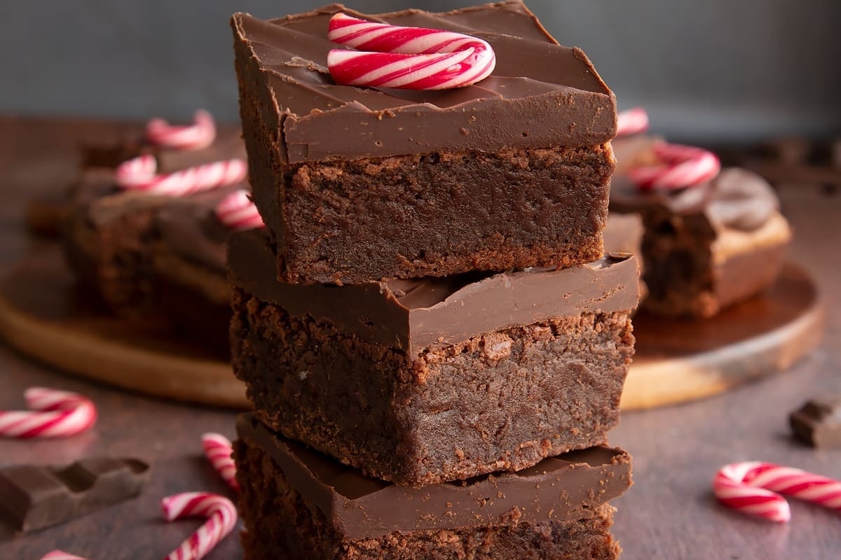 A stack of chocolate brownies with candy canes on top, perfect for those who love festive treats or are looking for a delicious recipe to try.