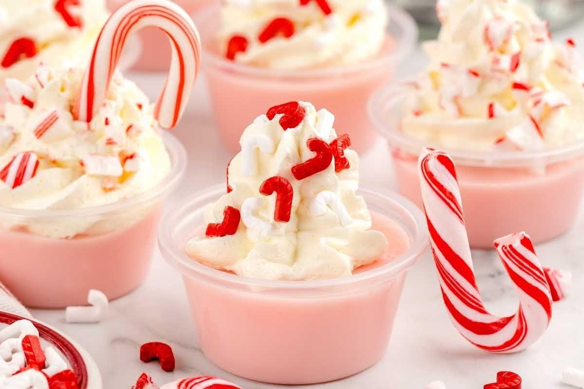 This description features a delectable recipe for candy cane ice cream cups topped with whipped cream and crushed candy canes.