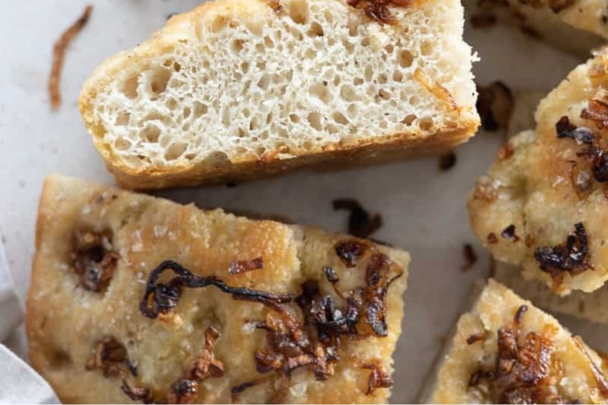 A Focaccia bread topped with onions.