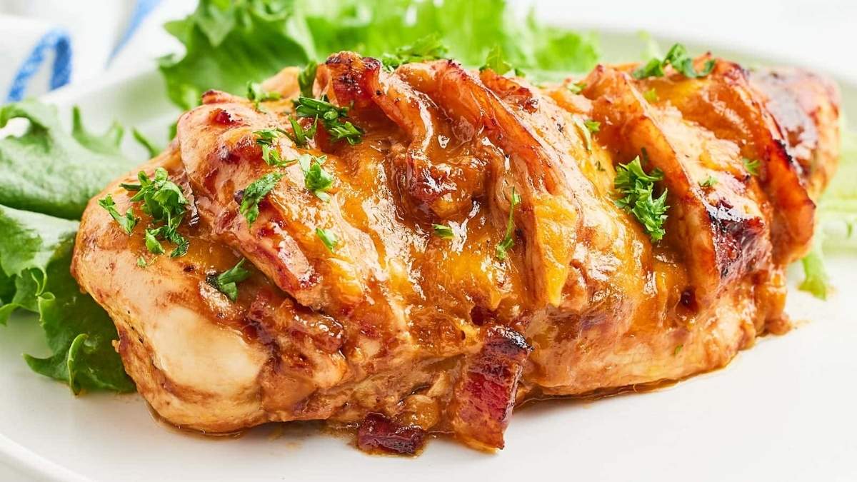A shared comfort food recipe featuring a chicken breast with bacon and lettuce displayed elegantly on a white plate.