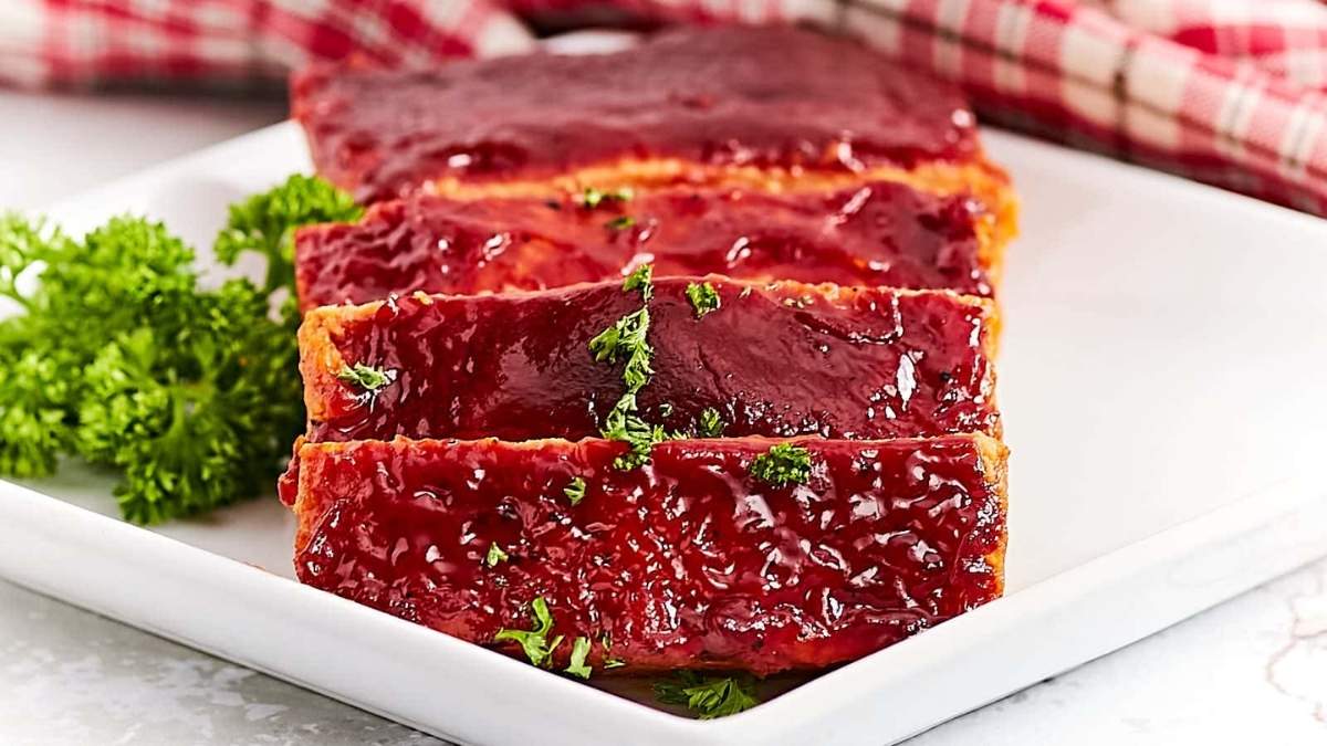 Bbq ribs on a plate with sauce and parsley.