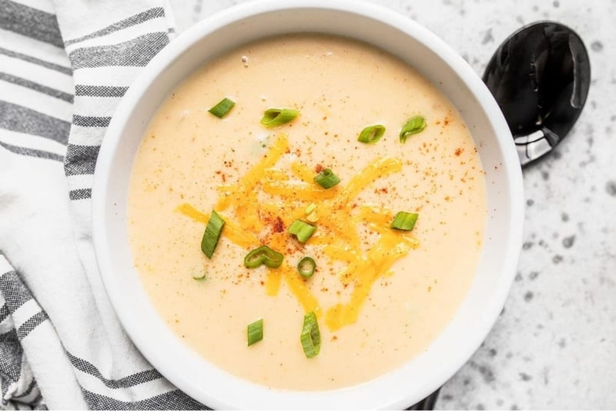 Delicious potato soup recipe served in a white bowl.