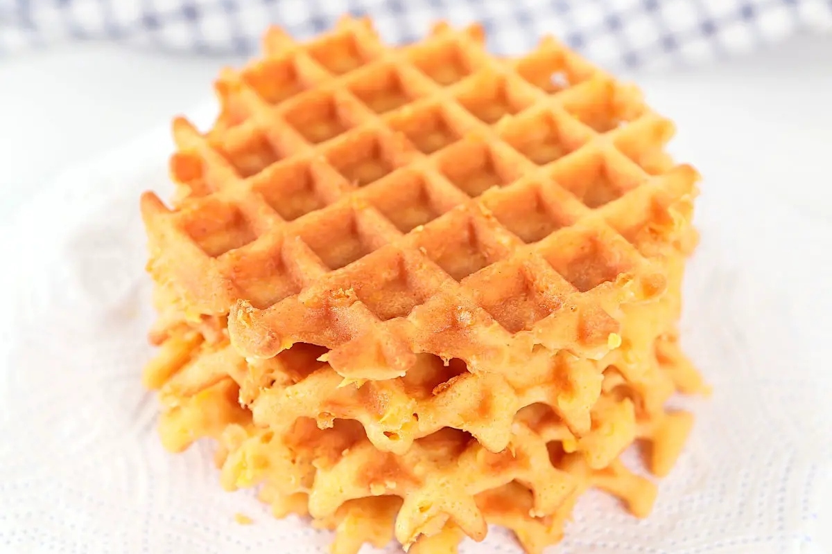 A stack of healthy waffles on a white napkin.