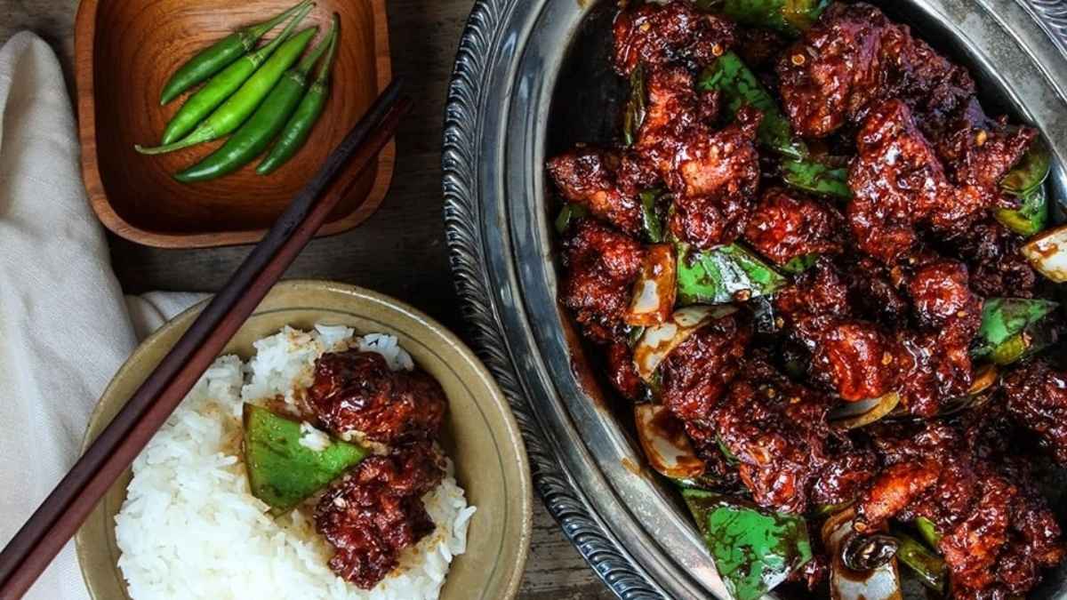 Chili chicken with rice on the side.
