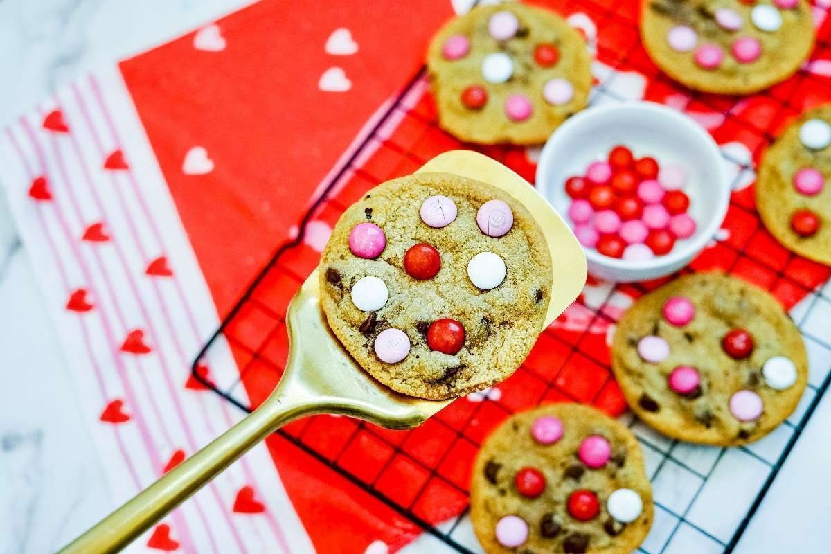 Valentine's Day cookies cooling on a rack.