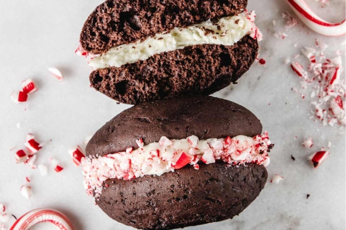 Two peppermint ice cream sandwiches with candy canes.