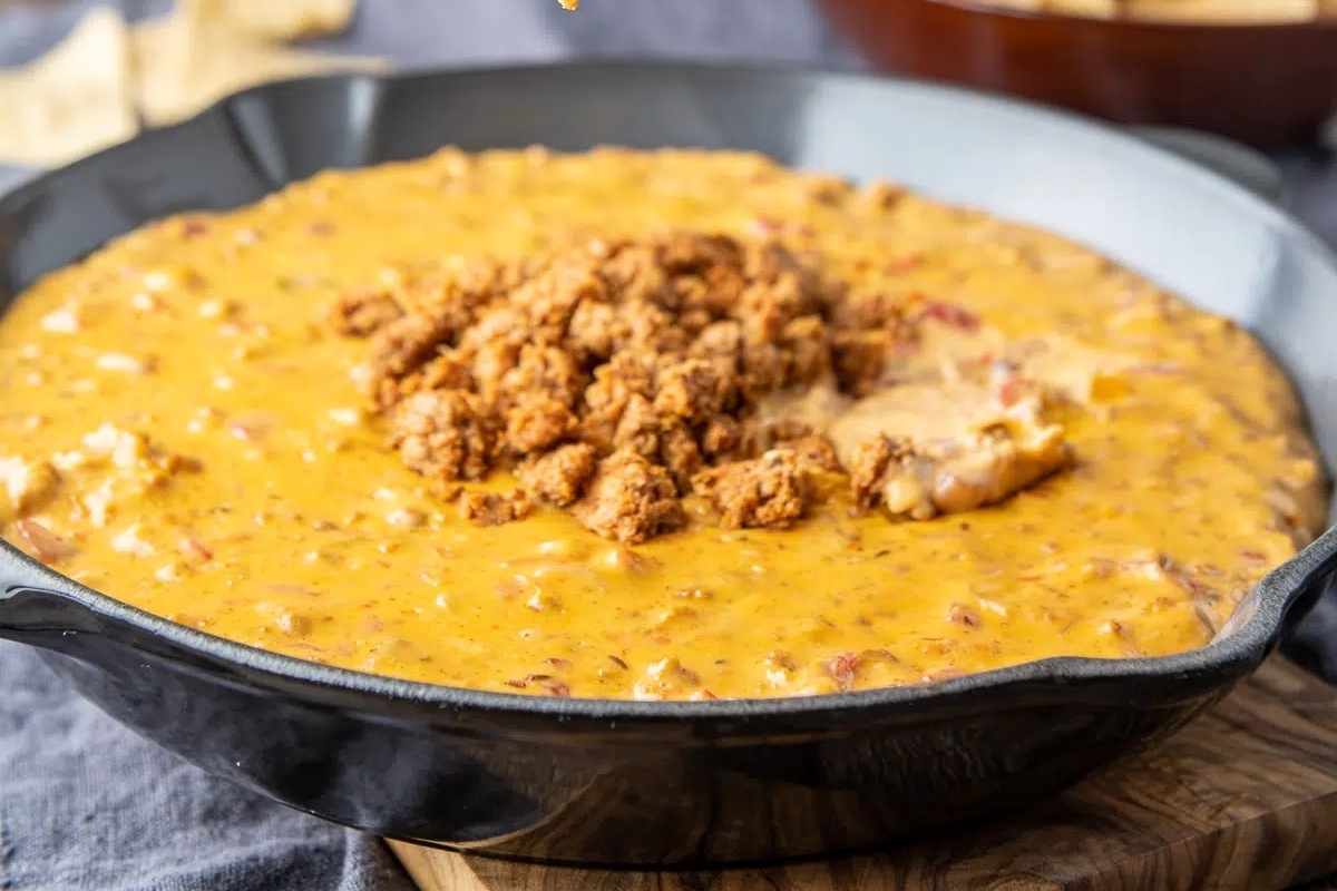 Creamy nacho cheese dip in a cast iron skillet.