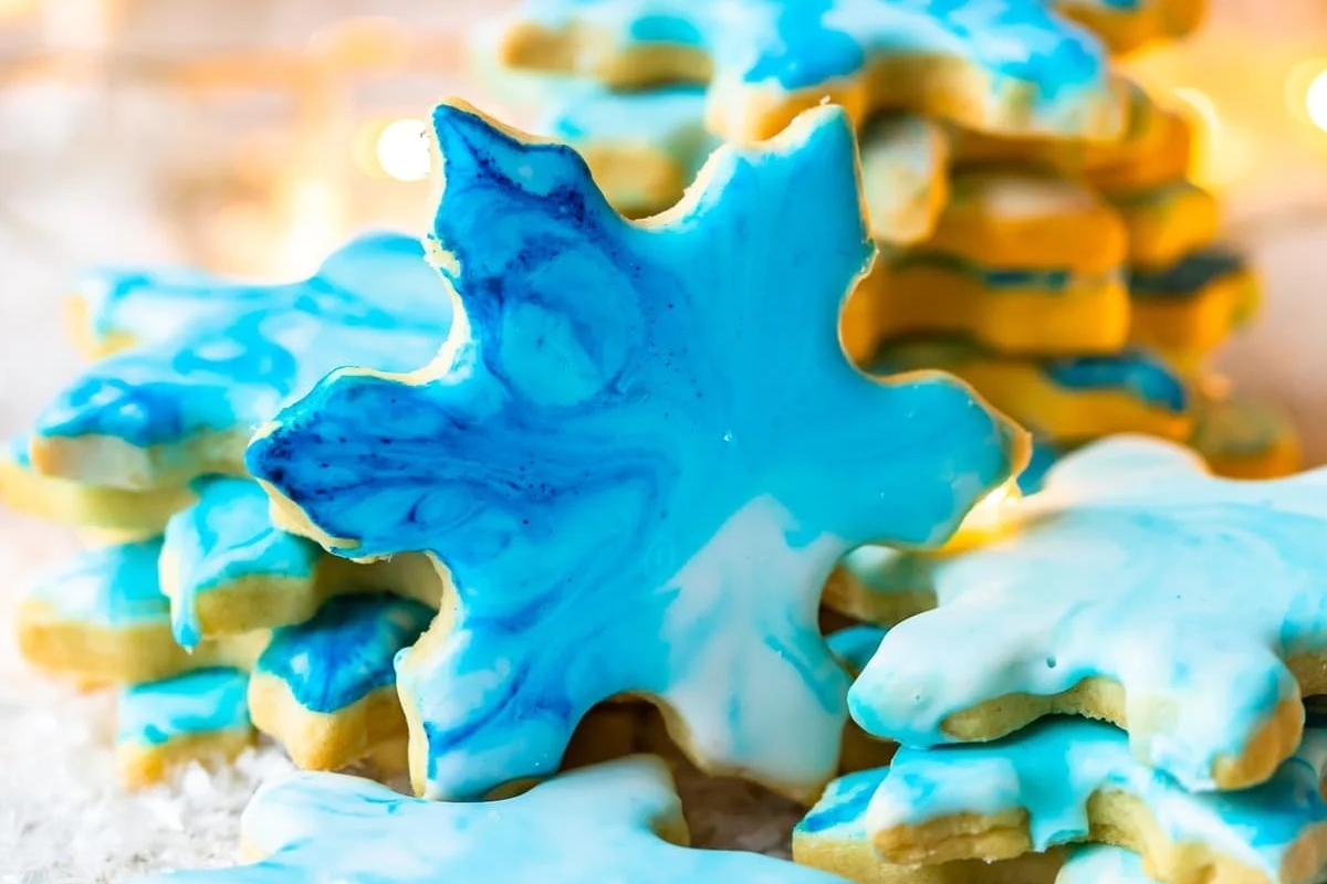Delicious Christmas snowflake cookies decorated with blue and white icing.