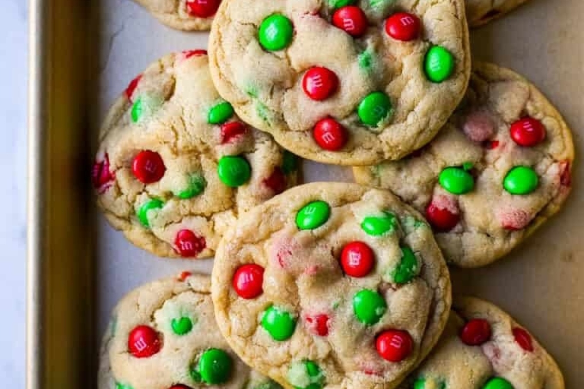 Freezable Christmas cookies with red and green m&m's on a baking sheet.