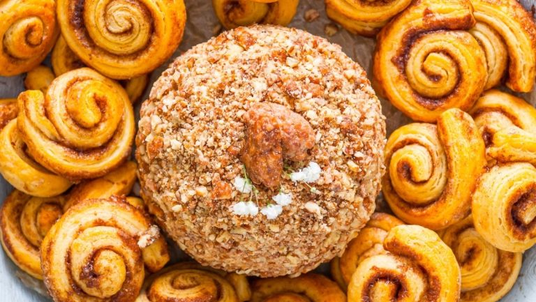 A bowl filled with appetizing cinnamon rolls and nuts, perfect for Christmas gatherings.