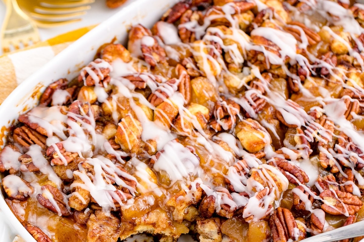 A sweet breakfast casserole dish with pecans and icing, perfect for Christmas morning.