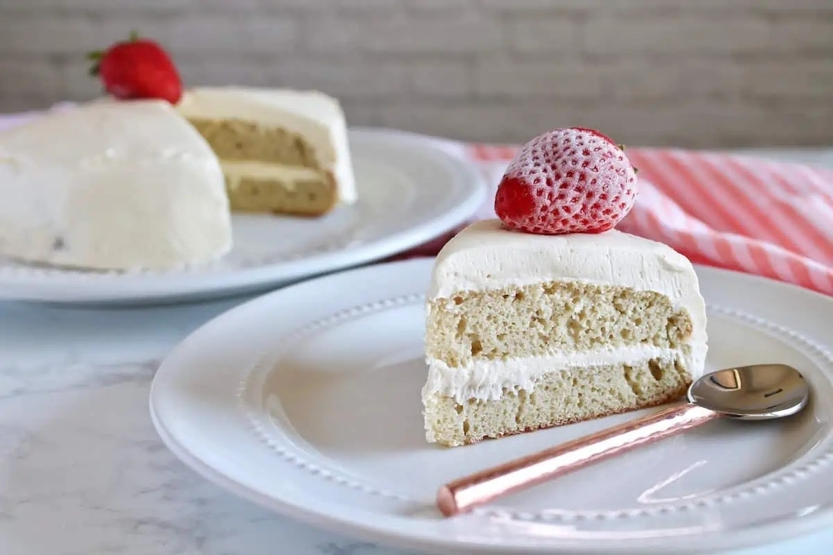 A mouthwatering slice of cake topped with fresh strawberries, elegantly presented on a festive Valentines' Day plate. This delectable dessert is the perfect treat to celebrate love and indulge