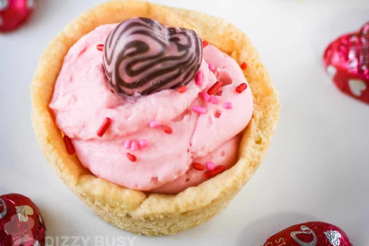 A Valentine's Day dessert with pink ice cream and chocolate hearts.