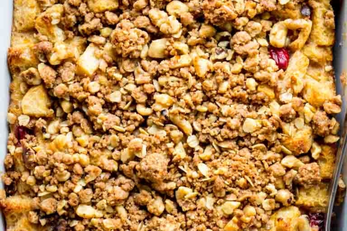 A Christmas morning breakfast dish featuring a cranberry crumble that bakes to perfection, served alongside a fork.