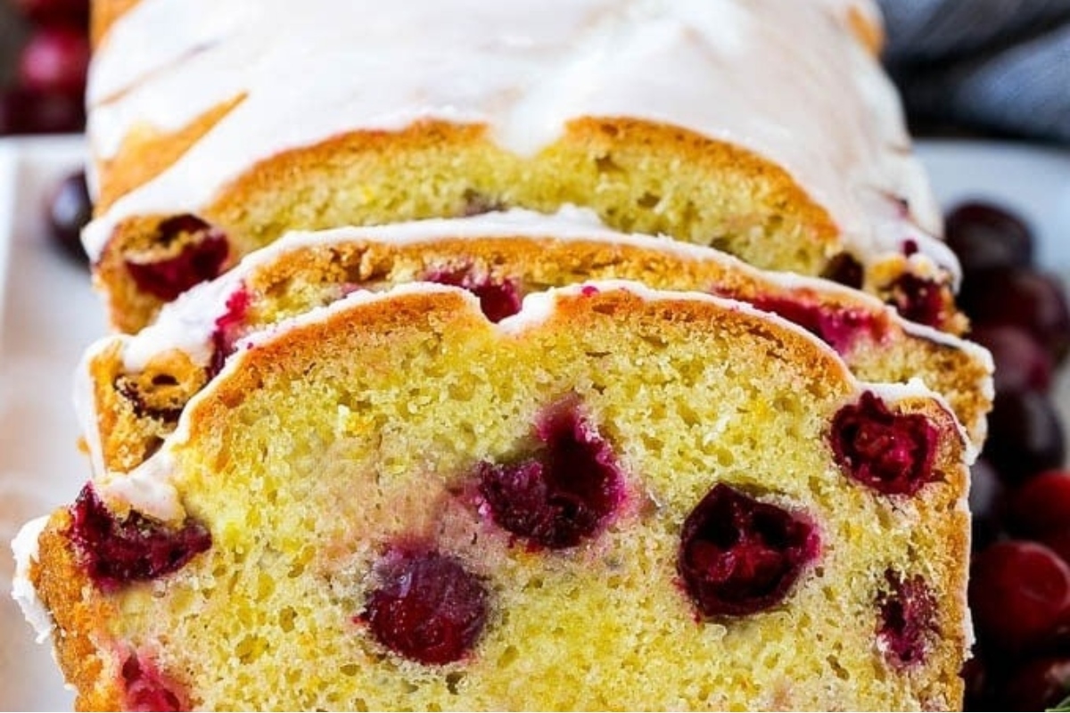 A delicious snack, cranberry bread, elegantly served on a white plate.